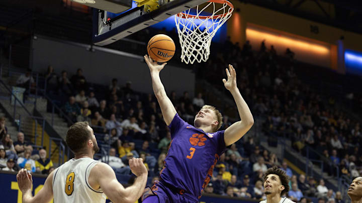 Feb 7, 2026; Berkeley, California, USA; Clemson Tigers forward Chase Thompson (3) lays the ball up between California Golden Bears defenders Milos Ilić (8) and Justin Pippen (10) during the first half at Haas Pavilion. Mandatory Credit: D. Ross Cameron-Imagn Images
