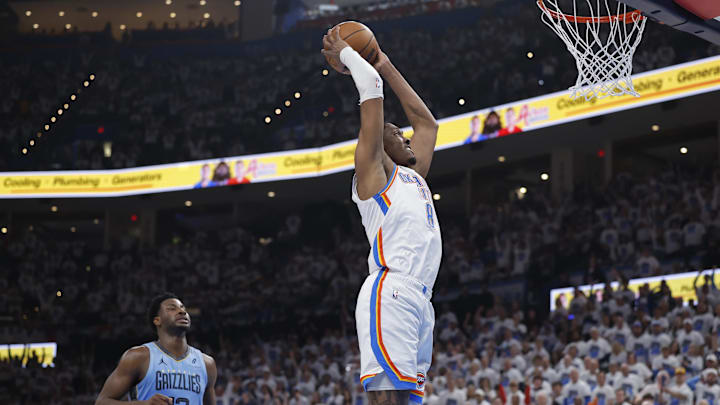Apr 20, 2025; Oklahoma City, Oklahoma, USA; Oklahoma City Thunder forward Jalen Williams (8) dunks as Memphis Grizzlies forward Jaren Jackson Jr. (13) watches from behind during the second quarter at Paycom Center. Mandatory Credit: Alonzo Adams-Imagn Images