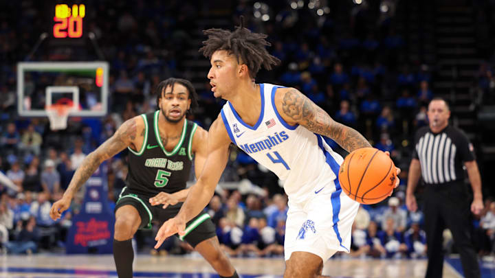 Jan 5, 2025; Memphis, Tennessee, USA; Memphis Tigers guard PJ Haggerty (4) drives to the basket against the North Texas Mean Green during the first half at FedExForum. Mandatory Credit: Wesley Hale-Imagn Images