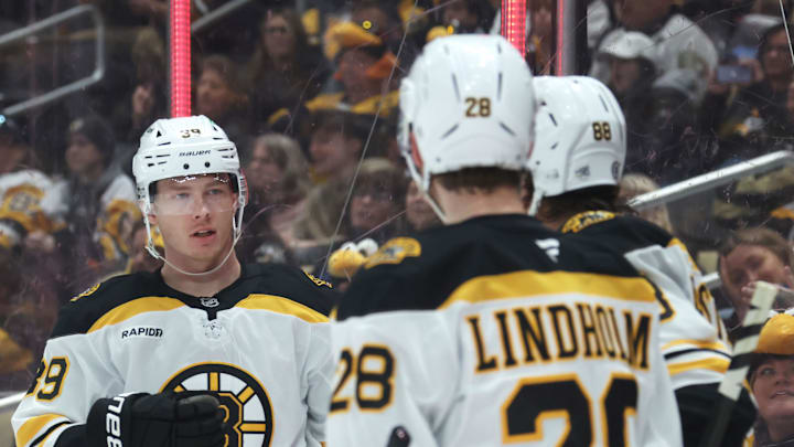 Apr 13, 2025; Pittsburgh, Pennsylvania, USA;  Boston Bruins center Morgan Geekie (39) celebrates with center Elias Lindholm (28) and right wing David Pastrnak (88)  after scoring a goal against the Pittsburgh Penguins during the second period at PPG Paints Arena. Mandatory Credit: Charles LeClaire-Imagn Images