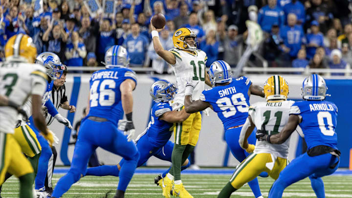 Green Bay Packers quarterback Jordan Love is pressured by Detroit Lions defenders Ezekiel Turner (47) and Za'Darius Smith.