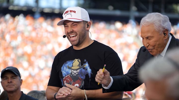 Former Oklahoma quarterback Baker Mayfield laughs beside ESPN's Lee Corso during the College GameDay