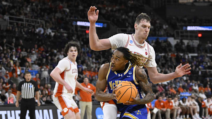 Mar 20, 2025; Providence, RI, USA; McNeese State Cowboys forward Christian Shumate (24) drives against Clemson Tigers center Viktor Lakhin (0) during the second half at Amica Mutual Pavilion. Mandatory Credit: Eric Canha-Imagn Images