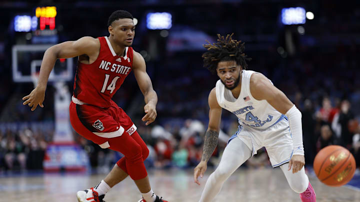 Mar 16, 2024; Washington, D.C., USA; North Carolina State Wolfpack guard Casey Morsell (14) knocks the ball away from North Carolina Tar Heels guard RJ Davis (4) during the second half at Capital One Arena. Mandatory Credit: Geoff Burke-Imagn Images