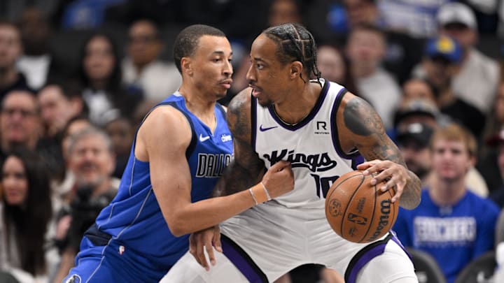 Feb 10, 2025; Dallas, Texas, USA; Sacramento Kings forward DeMar DeRozan (10) looks to move to the basket past Dallas Mavericks guard Dante Exum (0) during the first quarter at the American Airlines Center. Mandatory Credit: Jerome Miron-Imagn Images
