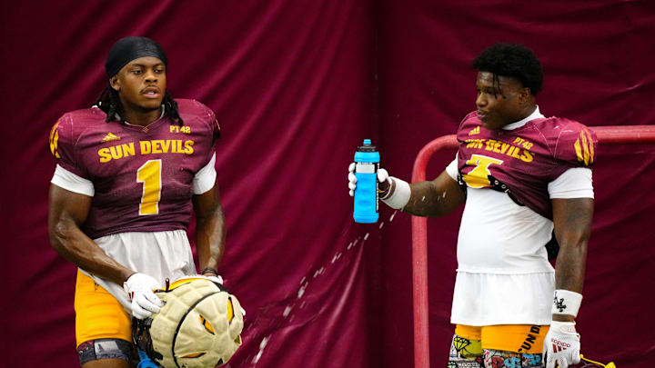Arizona State running backs Kyson Brown (1) and Raleek Brown (3) take a water break during a practice inside the Verde Dickey Dome in Tempe on August 12, 2025.