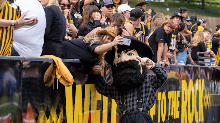 Sep 24, 2022; Boone, North Carolina, USA; A fan takes a selfie with Appalachian State Mountaineers mascot Yosef  prior to a game against the James Madison Dukes at Kidd Brewer Stadium. Mandatory Credit: David Yeazell-USA TODAY Sports