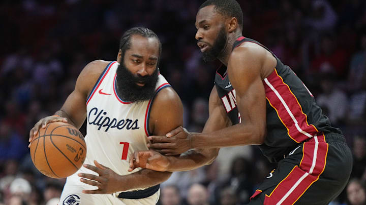 Mar 12, 2025; Miami, Florida, USA;  LA Clippers guard James Harden (1) drives to the basket against Miami Heat forward Andrew Wiggins (22) during the first half at Kaseya Center. Mandatory Credit: Jim Rassol-Imagn Images
