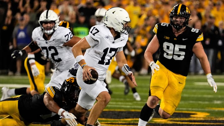 Penn State Nittany Lions quarterback Ethan Grunkemeyer (17) scrambles away from Iowa Hawkeyes defensive back Xavier Nwankpa (1) and Iowa Hawkeyes defensive lineman Aaron Graves (95).