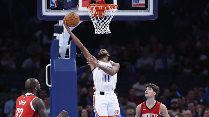 Oct 9, 2024; Oklahoma City, Oklahoma, USA; Oklahoma City Thunder guard Isaiah Joe (11) shoots between Houston Rockets forward Jeff Green (32) and guard Reed Sheppard (15) during the second half at Paycom Center. Mandatory Credit: Alonzo Adams-Imagn Images