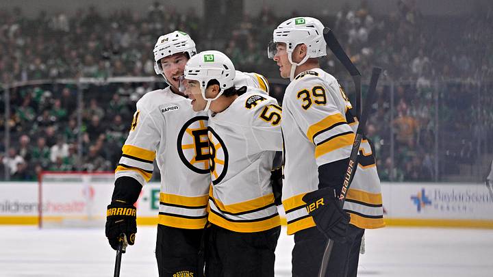 Oct 20, 2026; Dallas, Texas, USA; Boston Bruins left wing Tanner Jeannot (84) and center Matthew Poitras (51) and center Morgan Geekie (39) celebrates a goal scored by Poitras against the Dallas Stars during the first period at the American Airlines Center. Mandatory Credit: Jerome Miron-Imagn Images