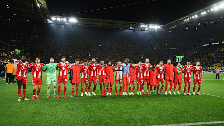 Bayern Munich players applauding fans after defeating Borussia Dortmund.