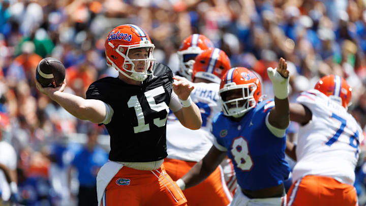 Apr 12, 2025; Gainesville, FL, USA; Florida Gators quarterback Harrison Bailey (15) throws under pressure from Florida Gators inside linebacker Aaron Chiles (8) during the first half at Ben Hill Griffin Stadium. Mandatory Credit: Matt Pendleton-Imagn Images