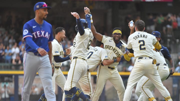 Jun 26, 2024; Milwaukee, Wisconsin, USA; Milwaukee Brewers second base Andruw Monasterio (14) celebrates with teammates after driving in the winning run against the Texas Rangers in the tenth inning at American Family Field. Mandatory Credit: Michael McLoone-USA TODAY Sports