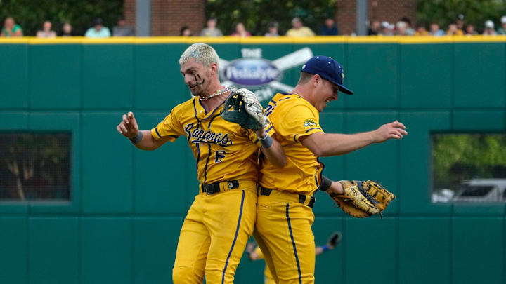 May 24, 2024; Columbus, Ohio, USA; Ryan Cox (6) and Eric Jones Jr. (3) of the Savannah Bananas celebrate after a play at Huntington Park.