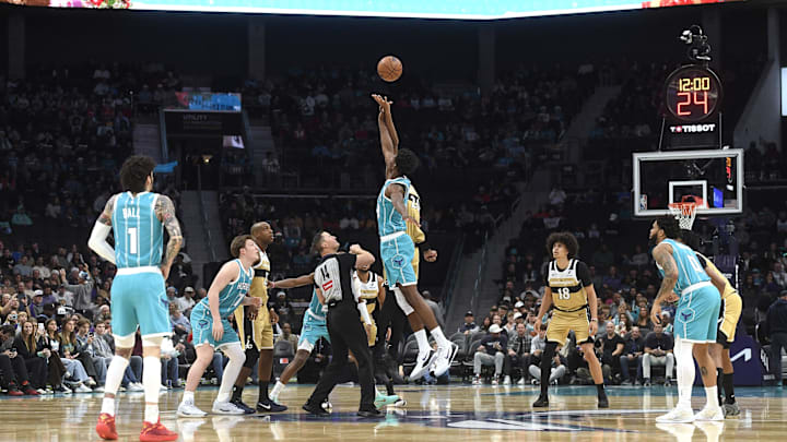 Dec 23, 2025; Charlotte, North Carolina, USA;  Charlotte Hornets center Moussa Diabate (14) and Washington Wizards forward Alex Sarr (20) tip off the game at the Spectrum Center. Mandatory Credit: Sam Sharpe-Imagn Images