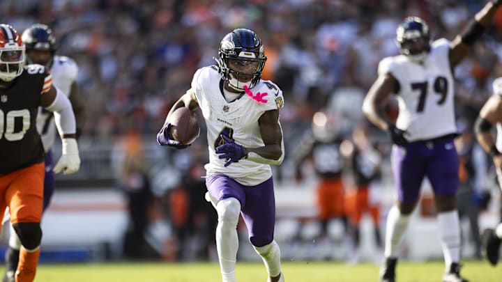 Oct 27, 2024; Cleveland, Ohio, USA; Baltimore Ravens wide receiver Zay Flowers (4) runs the ball against the Cleveland Browns during the fourth quarter at Huntington Bank Field. Mandatory Credit: Scott Galvin-Imagn Images
