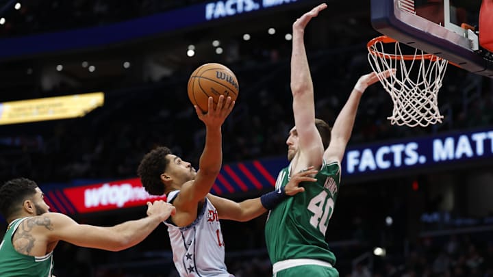 Dec 15, 2024; Washington, District of Columbia, USA; Washington Wizards guard Jordan Poole (13) shoots the ball as Boston Celtics center Luke Kornet (40) defends in the fourth quarter at Capital One Arena. Mandatory Credit: Geoff Burke-Imagn Images