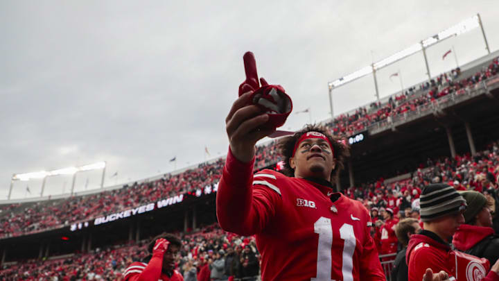 Ohio State Buckeyes wide receiver Jaxon Smith-Njigba (11) hands a glove to a fan following the Buckeyes' 56-7 victory against the Michigan State Spartans in a NCAA Division I football game at Ohio Stadium.