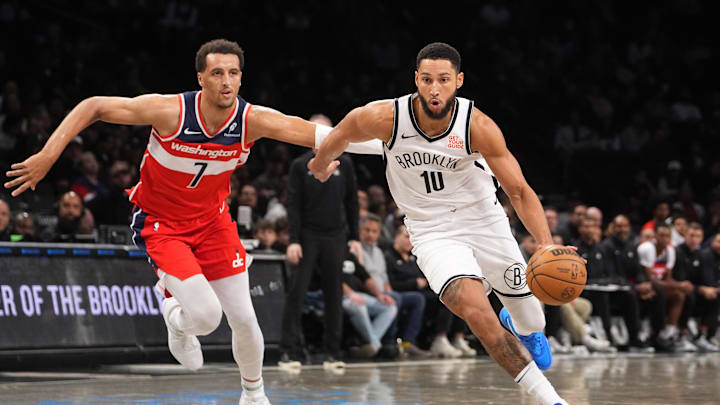 Oct 14, 2024; Brooklyn, New York, USA; Brooklyn Nets point guard Ben Simmons (10) dribbles the ball against Washington Wizards forward Patrick Baldwin Jr. (7) during the first half at Barclays Center. Mandatory Credit: Gregory Fisher-Imagn Images