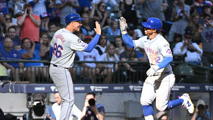 Sep 29, 2024; Milwaukee, Wisconsin, USA;New York Mets shortstop Francisco Lindor (12) is congratulated by New York Mets second base Eddy Alvarez (26) while rounding the bases after hitting a home run against the Milwaukee Brewers in the sixth inning at American Family Field. Mandatory Credit: Michael McLoone-Imagn Images