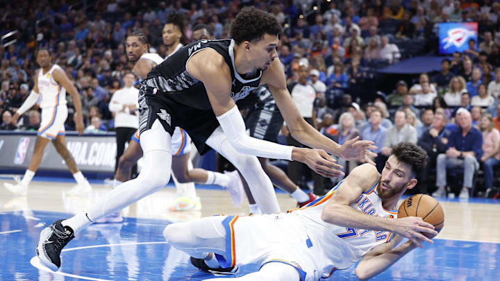 Oct 30, 2024; Oklahoma City, Oklahoma, USA; San Antonio Spurs center Victor Wembanyama (1) works to steal the ball from Oklahoma City Thunder forward Chet Holmgren (7) after he fell to the floor during the second half at Paycom Center. Mandatory Credit: Alonzo Adams-Imagn Images