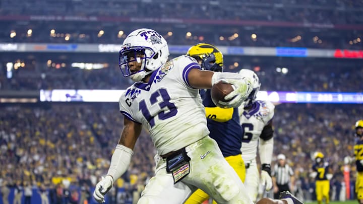 Dec 31, 2022; Glendale, Arizona, USA; TCU Horned Frogs linebacker Dee Winters (13) runs to score on a pick six in the third quarter against the Michigan Wolverines in the 2022 Fiesta Bowl at State Farm Stadium. Mandatory Credit: Mark J. Rebilas-Imagn Images