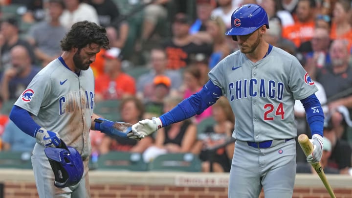 Jul 10, 2024; Baltimore, Maryland, USA; Chicago Cubs shortstop Dansby Swanson (7) greeted by outfielder Cody Bellinger (24) after scoring a run in the second inning against the Baltimore Orioles at Oriole Park at Camden Yards. 