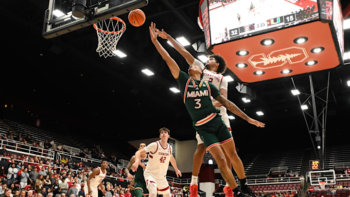 Jan 22, 2025; Stanford, California, USA; Miami (FL) Hurricanes guard Jalil Bethea (3) attempts a layup against Stanford Cardinal forward Donavin Young (2) in the first half at Maples Pavilion. Mandatory Credit: Eakin Howard-Imagn Images