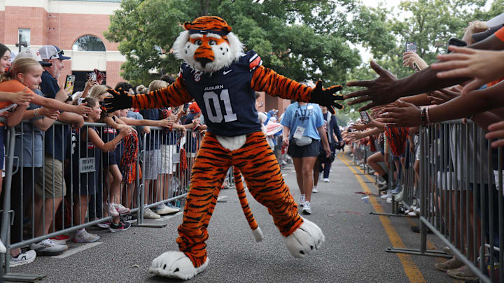 Sep 6, 2025; Auburn, Alabama, USA;  Aubie, the Auburn Tigers mascot, greets fans as he goes through Tiger Walk before the game against the Ball State Cardinals at Jordan-Hare Stadium. Mandatory Credit: John Reed-Imagn Images
