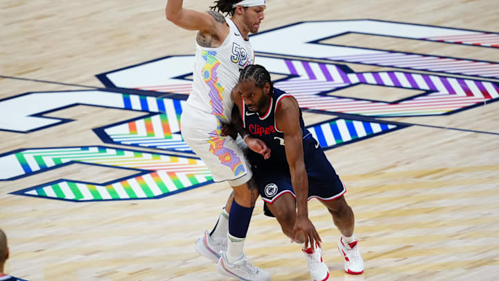 Apr 29, 2025; Denver, Colorado, USA; LA Clippers forward Kawhi Leonard (2) drives past Denver Nuggets forward Aaron Gordon (32) in the second quarter during five of first round for the 2025 NBA Playoffs at Ball Arena. Mandatory Credit: Ron Chenoy-Imagn Images