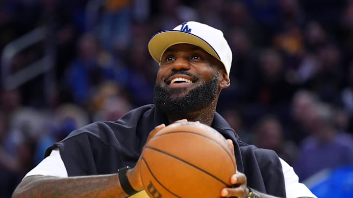 Oct 5, 2025; San Francisco, California, USA; Los Angeles Lakers forward LeBron James (23), wearing a Los Angeles Dodgers hat, watches from the sideline during a break against the Golden State Warriors in the third quarter at Chase Center. Mandatory Credit: David Gonzales-Imagn Images Oct 5, 2025; San Francisco, California, USA; Los Angeles Lakers forward LeBron James (23), wearing a Los Angeles Dodgers hat, watches from the sideline during a break against the Golden State Warriors in the third quarter at Chase Center. Mandatory Credit: David Gonzales-Imagn Images