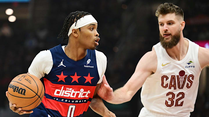 Dec 13, 2024; Cleveland, Ohio, USA; Washington Wizards guard Bilal Coulibaly (0) drives to the basket against Cleveland Cavaliers forward Dean Wade (32) during the first quarter at Rocket Mortgage FieldHouse. Mandatory Credit: Ken Blaze-Imagn Images