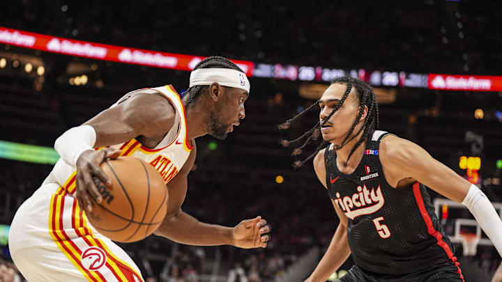 Apr 1, 2025; Atlanta, Georgia, USA; Atlanta Hawks guard Caris LeVert (3) dribbles against Portland Trail Blazers guard Dalano Banton (5) during the first half at State Farm Arena. Mandatory Credit: Dale Zanine-Imagn Images