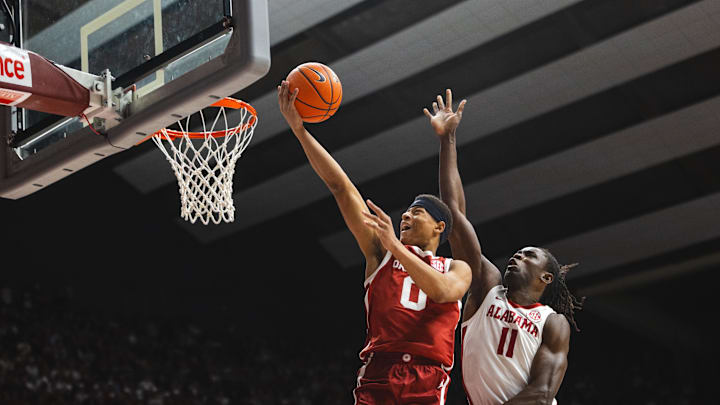 Jan 4, 2025; Tuscaloosa, Alabama, USA; Oklahoma Sooners guard Jeremiah Fears (0) shoots for the basket against Alabama Crimson Tide center Clifford Omoruyi (11) during the first half at Coleman Coliseum. Mandatory Credit: Will McLelland-Imagn Images