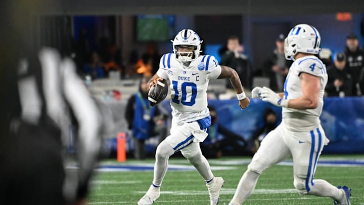 Dec 6, 2025; Charlotte, NC, USA; Duke Blue Devils quarterback Darian Mensah (10) runs with the ball in the second quarter against the Virginia Cavaliers during the 2025 ACC Championship game at Bank of America Stadium. Mandatory Credit: Bob Donnan-Imagn Images