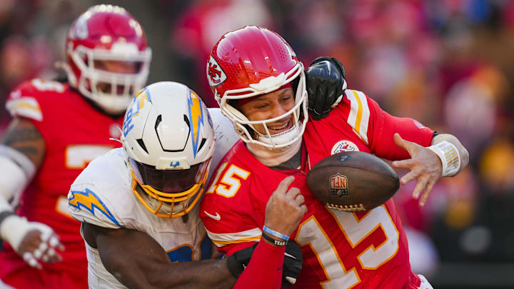 Dec 14, 2025; Kansas City, Missouri, USA; Kansas City Chiefs quarterback Patrick Mahomes (15) is sacked by Los Angeles Chargers linebacker Odafe Oweh (98) during the second half at GEHA Field at Arrowhead Stadium. Mandatory Credit: Jay Biggerstaff-Imagn Images