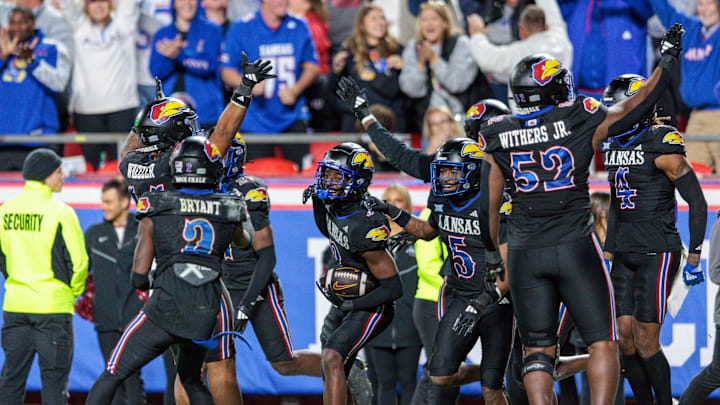 Nov 9, 2024; Kansas City, Missouri, USA; Kansas Jayhawks cornerback Mello Dotson (3) celebrates after scoring a touch down during the fourth quarter against the Iowa State Cyclones at GEHA Field at Arrowhead Stadium. Mandatory Credit: William Purnell-Imagn Images