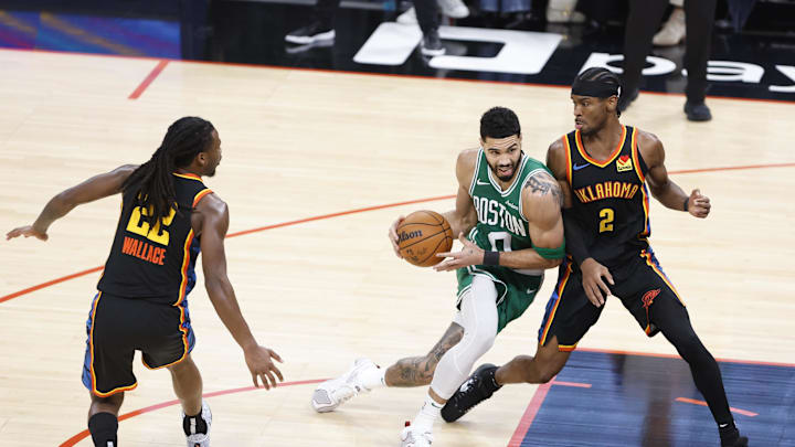 Jan 5, 2025; Oklahoma City, Oklahoma, USA; Boston Celtics forward Jayson Tatum (0) drives to the basket against Oklahoma City Thunder guard Shai Gilgeous-Alexander (2) during the third quarter at Paycom Center. Mandatory Credit: Alonzo Adams-Imagn Images