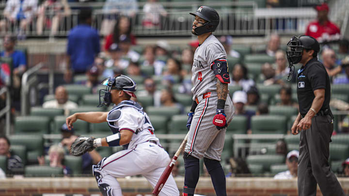 Apr 20, 2025; Cumberland, Georgia, USA; Minnesota Twins shortstop Carlos Correa (4) reacts after being called out on strikes against the Atlanta Braves during the seventh inning at Truist Park.