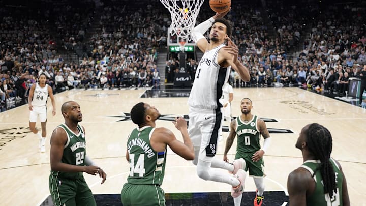 Jan 31, 2025; San Antonio, Texas, USA; San Antonio Spurs center Victor Wembanyama (1) dunks over Milwaukee Bucks forward Giannis Antetokounmpo (34) during the second half at Frost Bank Center. Mandatory Credit: Scott Wachter-Imagn Images