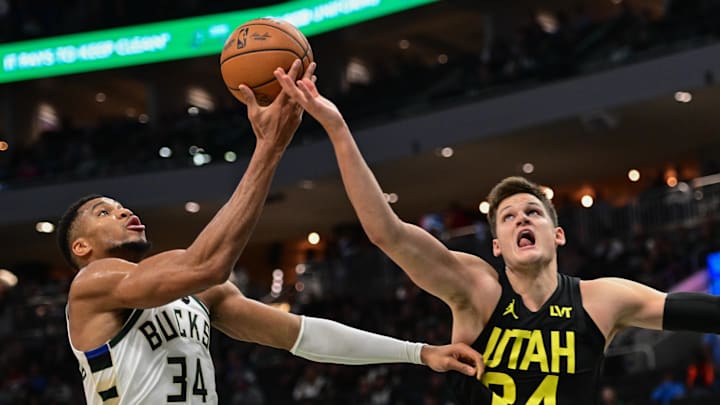 Nov 7, 2024; Milwaukee, Wisconsin, USA; Milwaukee Bucks forward Giannis Antetokounmpo (34) and Utah Jazz center Walker Kessler (24) reach for a rebound in the second quarter at Fiserv Forum. Mandatory Credit: Benny Sieu-Imagn Images