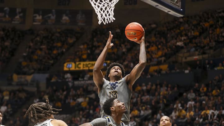 Mar 8, 2025; Morgantown, West Virginia, USA; West Virginia Mountaineers forward Amani Hansberry (13) shoots in the lane against the UCF Knights during the first half at WVU Coliseum. Mandatory Credit: Ben Queen-Imagn Images
