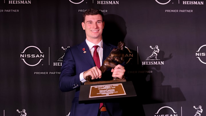 Dec 13, 2025; New York, NY, USA; Indiana Hoosiers quarterback Fernando Mendoza poses for photos with the Heisman trophy during a press conference at the New York Marriott Marquis after winning the award. Mandatory Credit: Brad Penner-Imagn Images