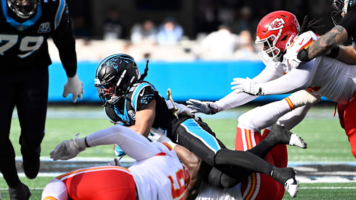 Nov 24, 2024; Charlotte, North Carolina, USA; Carolina Panthers running back Jonathon Brooks (24) is tackled by Kansas City Chiefs linebacker Nick Bolton (32) in the second quarter at Bank of America Stadium. Mandatory Credit: Bob Donnan-Imagn Images