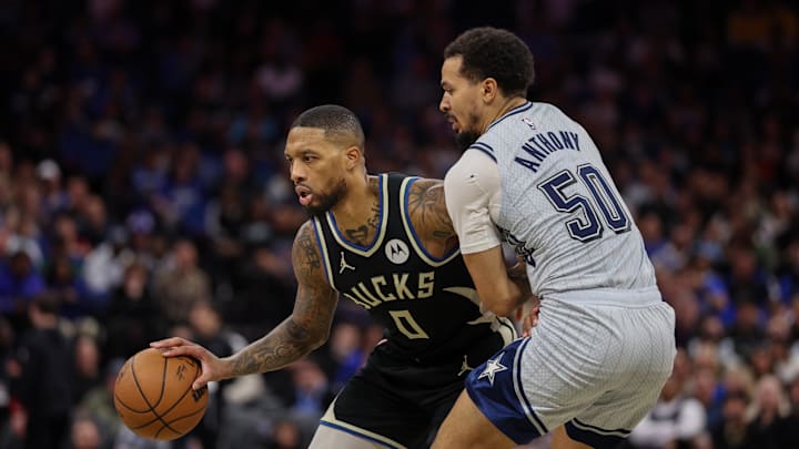 Jan 10, 2025; Orlando, Florida, USA; Milwaukee Bucks guard Damian Lillard (0) is guarded by Orlando Magic guard Cole Anthony (50) in the in the second quarter at Kia Center. Mandatory Credit: Nathan Ray Seebeck-Imagn Images