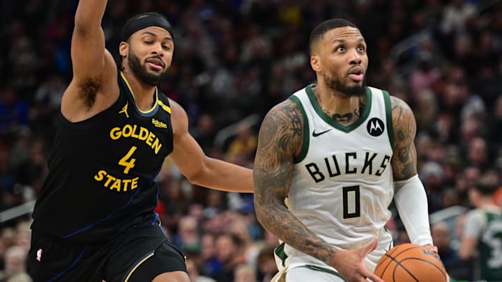 Feb 10, 2025; Milwaukee, Wisconsin, USA; Milwaukee Bucks guard Damian Lillard (0) looks for a shot against Golden State Warriors forward Moses Moody (4) in the third quarter at Fiserv Forum. Mandatory Credit: Benny Sieu-Imagn Images Feb 10, 2025; Milwaukee, Wisconsin, USA; Milwaukee Bucks guard Damian Lillard (0) looks for a shot against Golden State Warriors forward Moses Moody (4) in the third quarter at Fiserv Forum. Mandatory Credit: Benny Sieu-Imagn Images