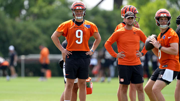 Jul 26, 2024; Cincinnati, OH, USA;  Cincinnati Bengals quarterback Joe Burrow (9) observes quarterback Jake Browning (right) throw during training camp practice at Kettering Health Practice Fields. Mandatory Credit: Kareem Elgazzar-Imagn Images