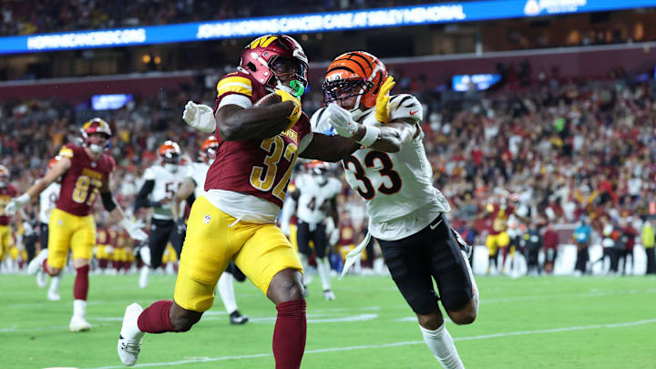 Washington Commanders running back Jacory Croskey-Merritt scores a touchdown as Cincinnati Bengals safety Daijahn Anthony