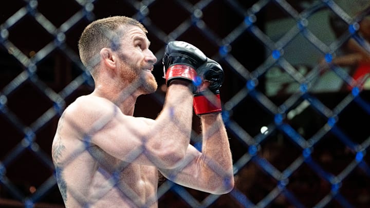 Cory Sandhagen (red gloves) reacts after defeating Deiveson Figueiredo (blue gloves) during UFC Fight Night at Wells Fargo Arena on May 3, 2025, in Des Moines.